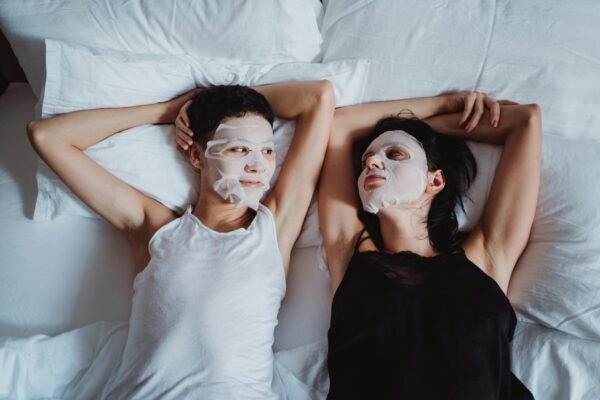 Couple in Bed with Face Masks