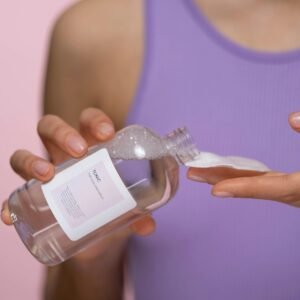 Woman Holding Clear Bottle Of Facial Tonic